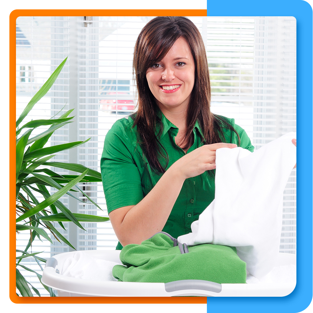 Woman smiling while doing laundry