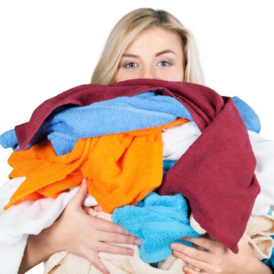 woman holding a pile of laundry